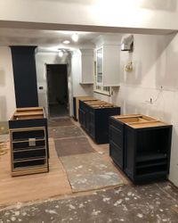 Flatpack kitchen navy carcasses being installed — Sydney